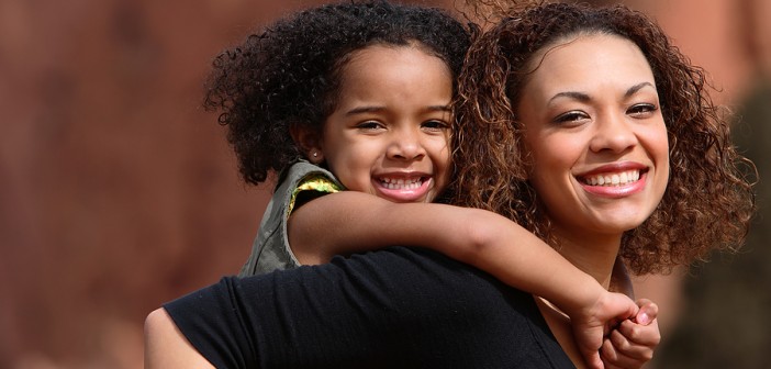 Mother's day Brazil: Mother holds child on her back